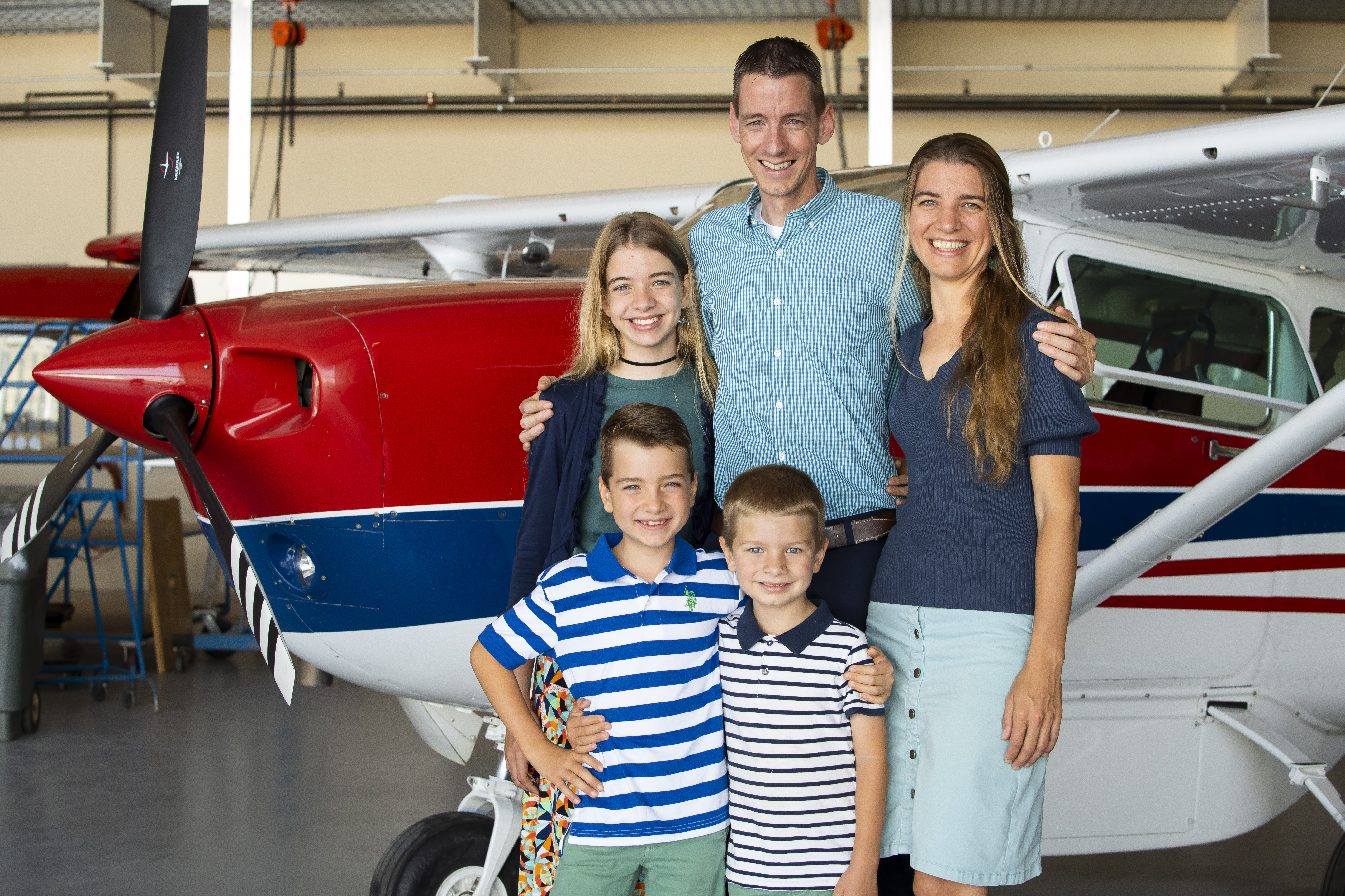The Rietveld family — Wilbert, Marieke, Doortje, Lucas and Daniel — in a MAF hangar