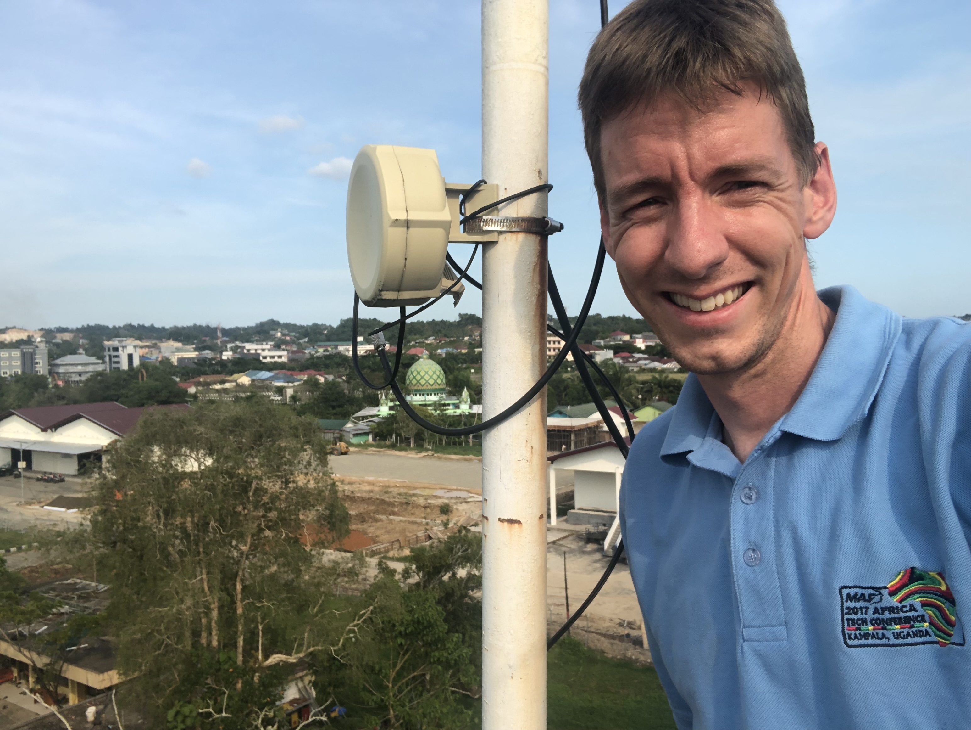 Wilbert Rietveld with antenna equipment on a rooftop