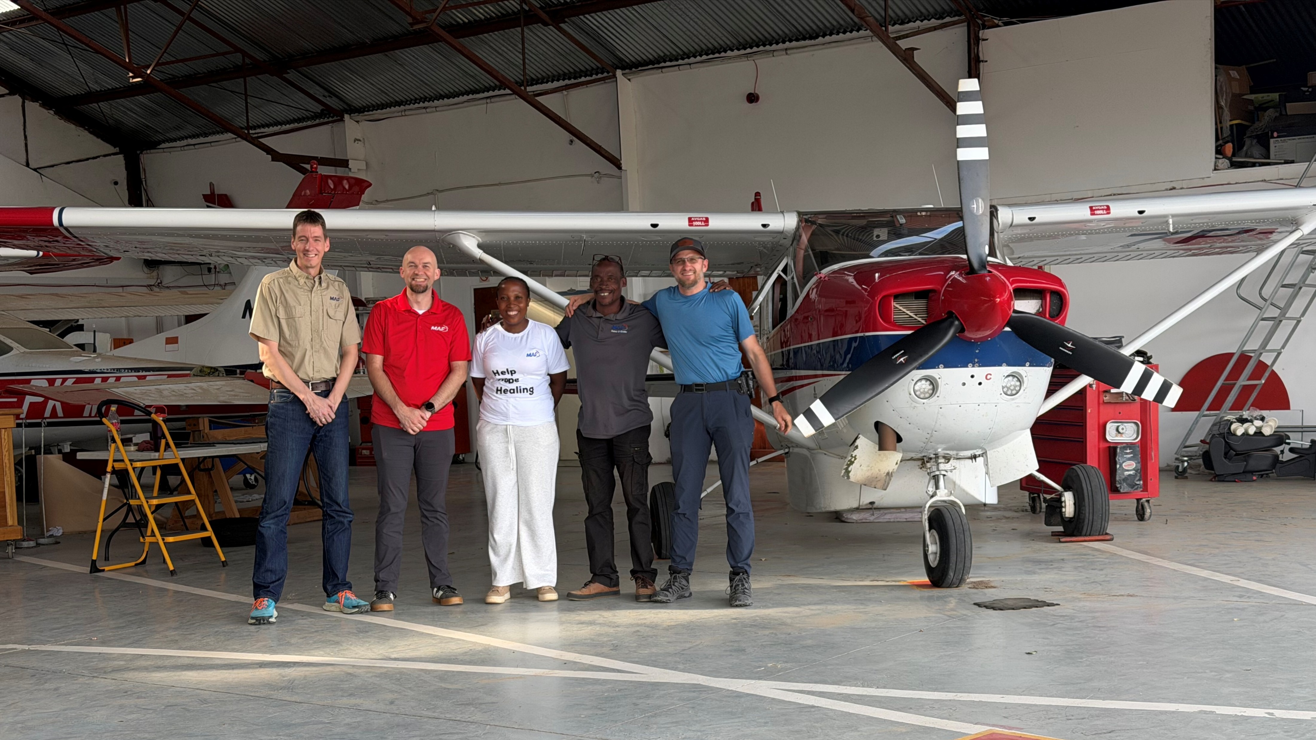 Wilbert Rietveld with his international MAF IT team in an airplane hangar